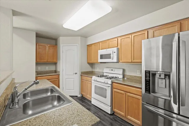 a kitchen with a sink stove and refrigerator