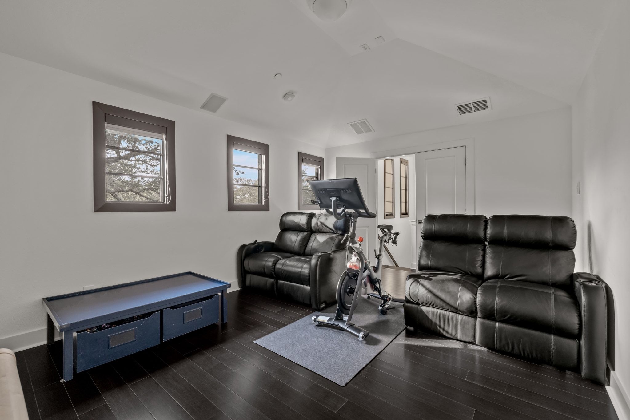 4720 Rockcliff Road, Unit 1 Austin, TX 78746 - Photo 36 of 39 Rich hardwood flooring complements a versatile bonus room with ample light.