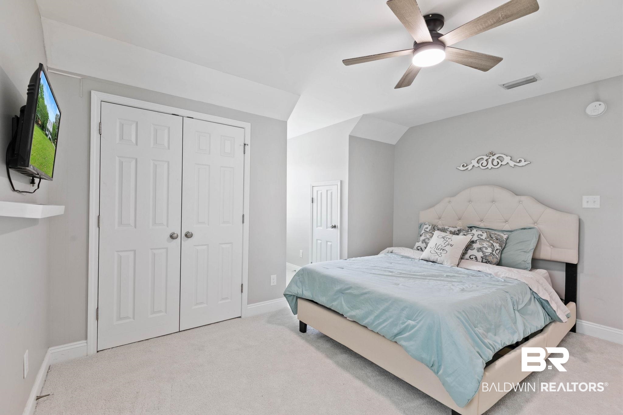 22810 High Ridge Road Fairhope, AL 36532 - Photo 48 of 78 Carpeted interior space featuring a ceiling fan with integrated lighting, bi-fold panel doors, and neutral wall tones