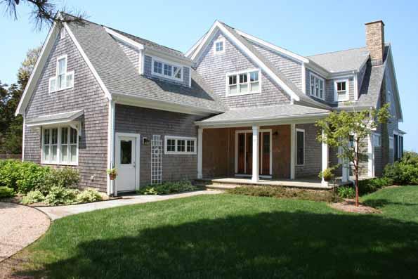 64 Gibson Road Orleans, MA 02653 - Photo 2 of 27 a front view of a house with a yard and garage