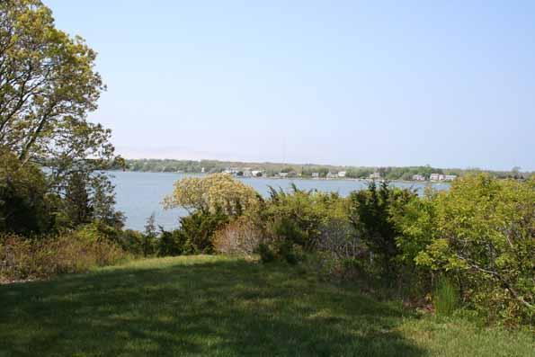 64 Gibson Road Orleans, MA 02653 - Photo 4 of 27 a view of a lake with houses in the back