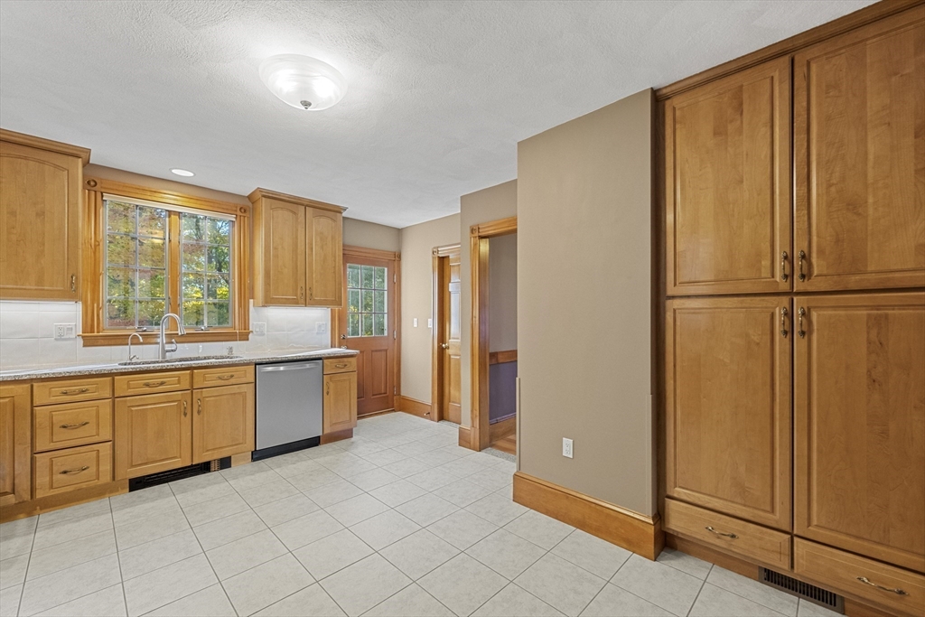 3 Laurel Street Woburn, MA 01801 - Photo 17 of 40 a kitchen with granite countertop cabinets and refrigerator