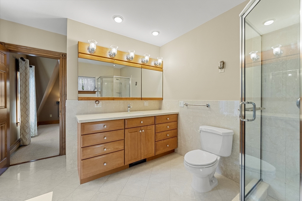 3 Laurel Street Woburn, MA 01801 - Photo 26 of 40 a spacious bathroom with a granite countertop toilet sink and mirror