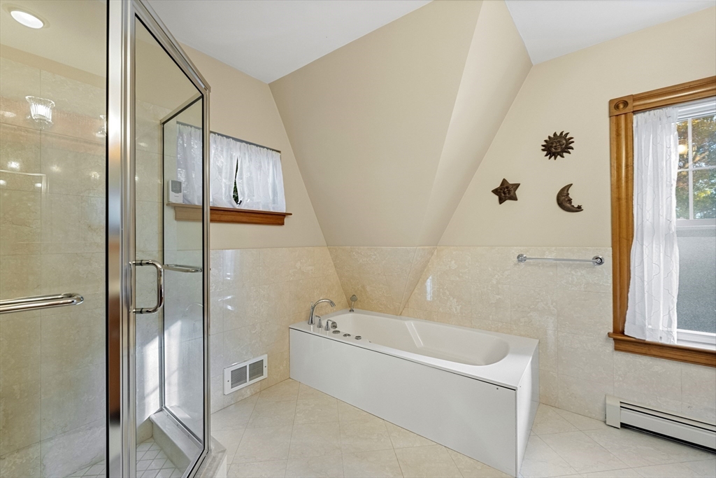 3 Laurel Street Woburn, MA 01801 - Photo 27 of 40 a bathroom with a bathtub and a shower