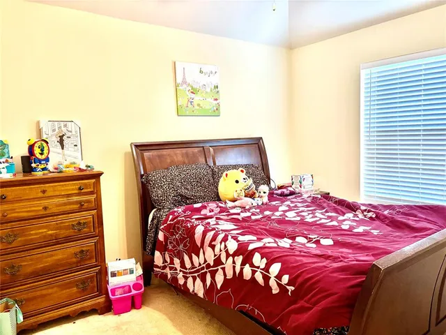 a bedroom with a bed and a dresser in it