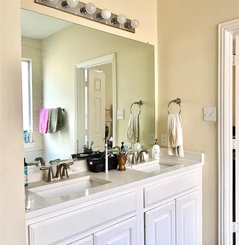 a bathroom with a double vanity sink and mirror