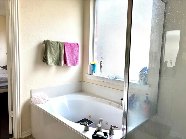 a bathroom with a tub and shower