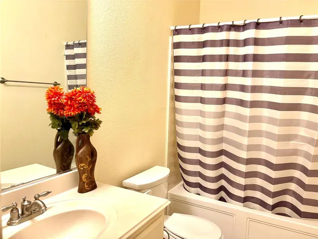 a bathroom with a sink toilet and a mirror