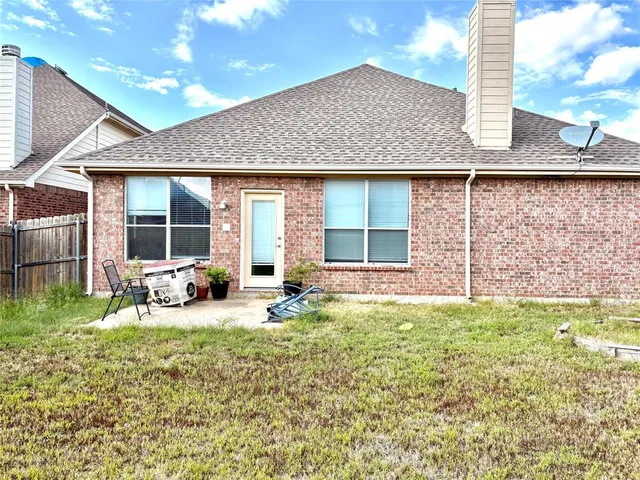 a view of a house with outdoor space and sitting area