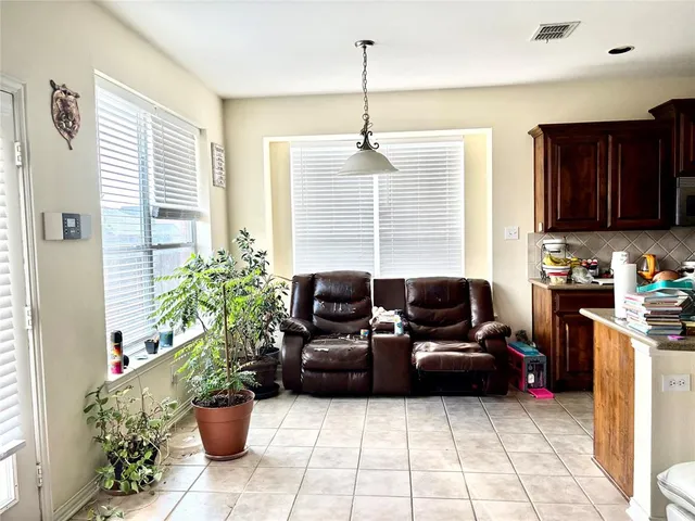 a living room with furniture potted plant and a window