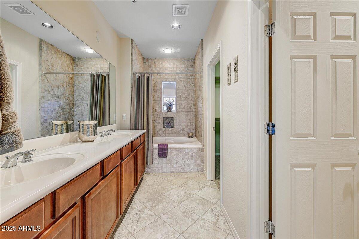 3935 East Rough Rider Road, Unit 1191 Phoenix, AZ 85050 - Photo 13 of 32 a bathroom with a double vanity sink and a mirror