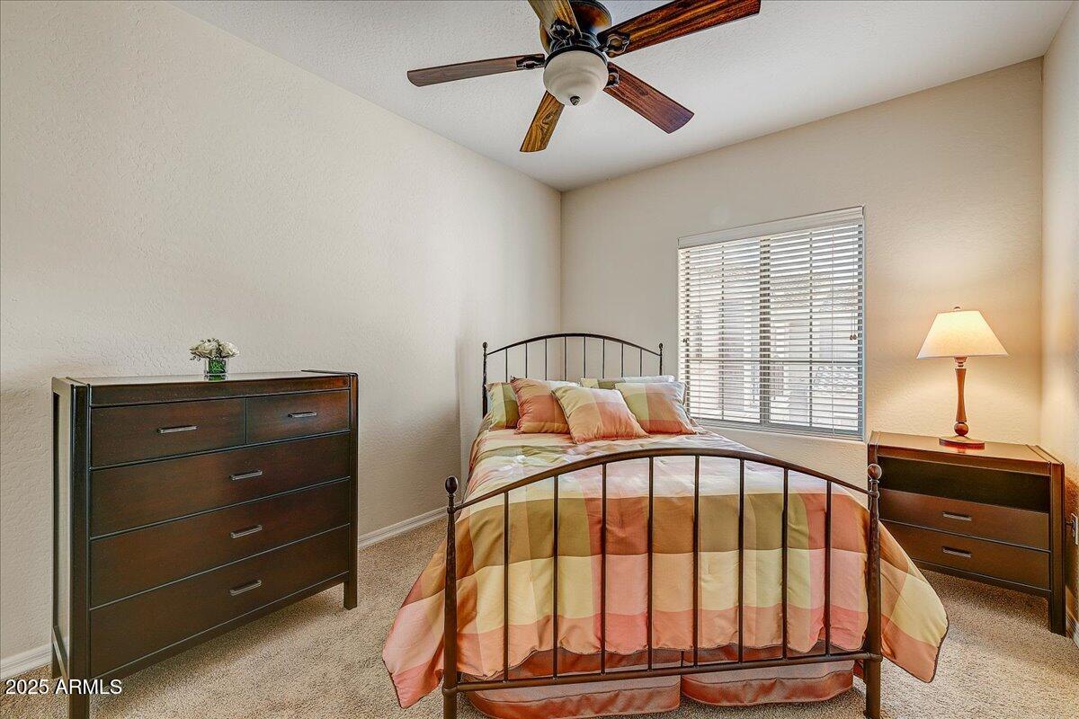 3935 East Rough Rider Road, Unit 1191 Phoenix, AZ 85050 - Photo 16 of 32 a view of a bedroom with a bed and a window