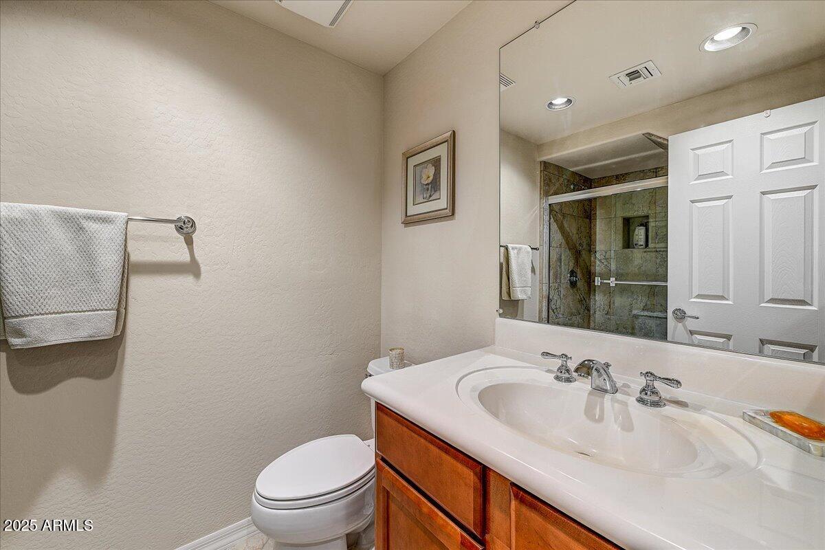 3935 East Rough Rider Road, Unit 1191 Phoenix, AZ 85050 - Photo 17 of 32 a bathroom with a sink a toilet and a mirror