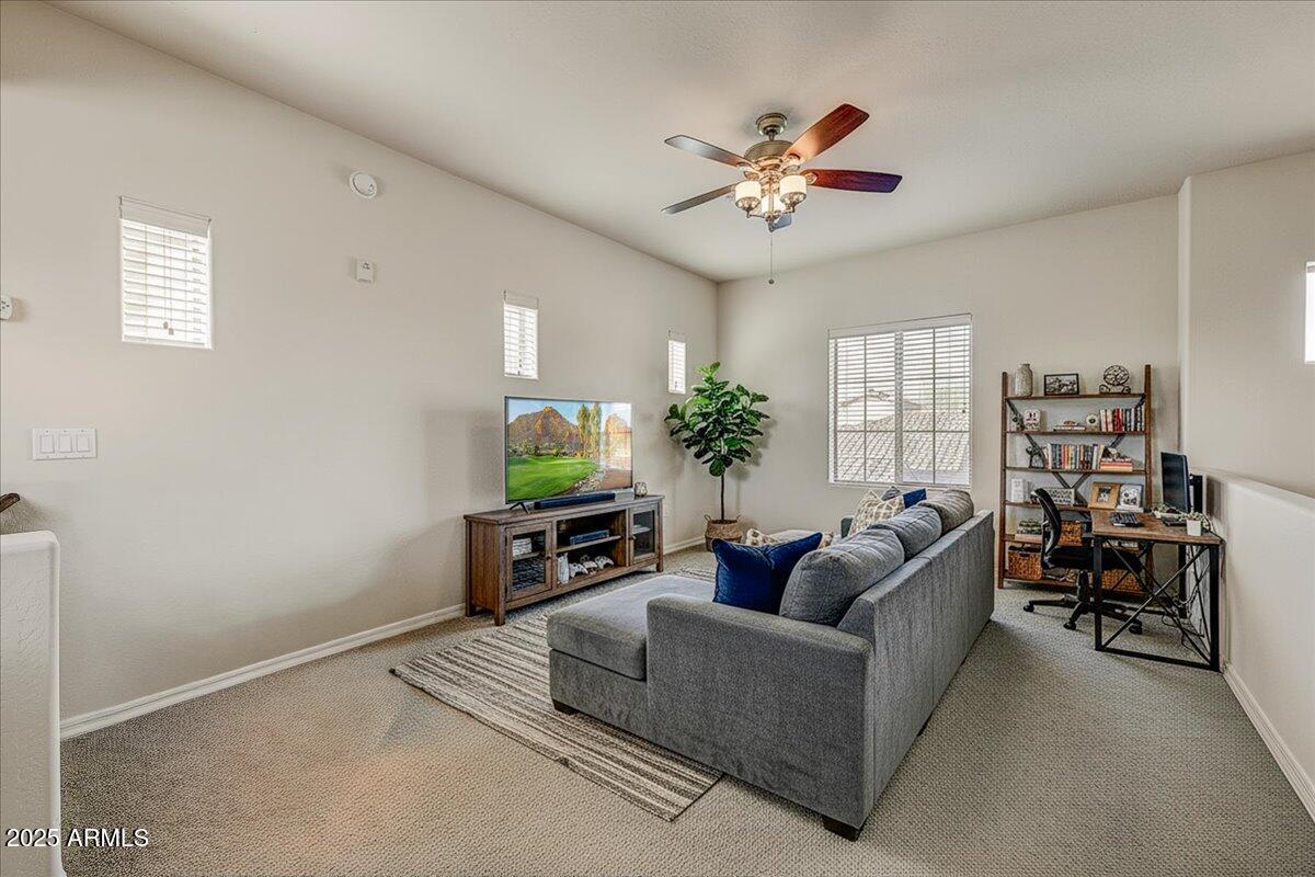 3935 East Rough Rider Road, Unit 1191 Phoenix, AZ 85050 - Photo 19 of 32 a living room with furniture and a flat screen tv