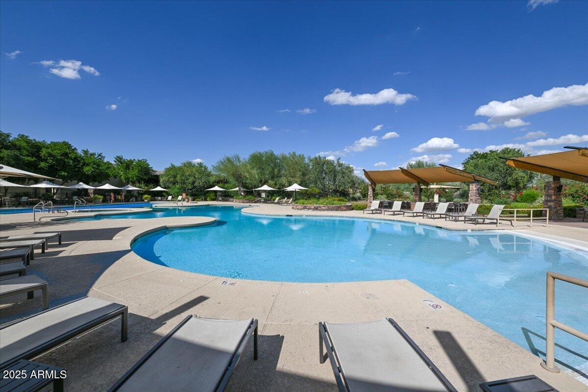 3935 East Rough Rider Road, Unit 1191 Phoenix, AZ 85050 - Photo 30 of 32 a view of a swimming pool with an outdoor seating