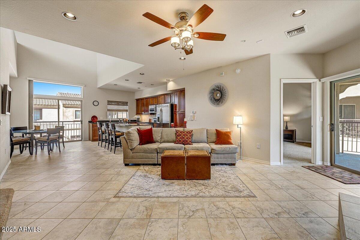 3935 East Rough Rider Road, Unit 1191 Phoenix, AZ 85050 - Photo 3 of 32 a living room with furniture and a table