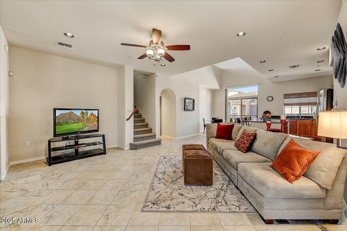 3935 East Rough Rider Road, Unit 1191 Phoenix, AZ 85050 - Photo 5 of 32 a living room with furniture and a flat screen tv