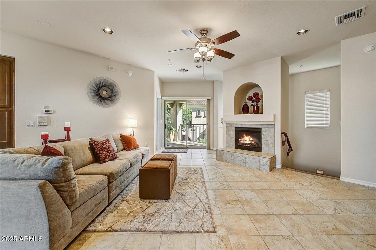 3935 East Rough Rider Road, Unit 1191 Phoenix, AZ 85050 - Photo 6 of 32 a living room with furniture a fireplace and a window