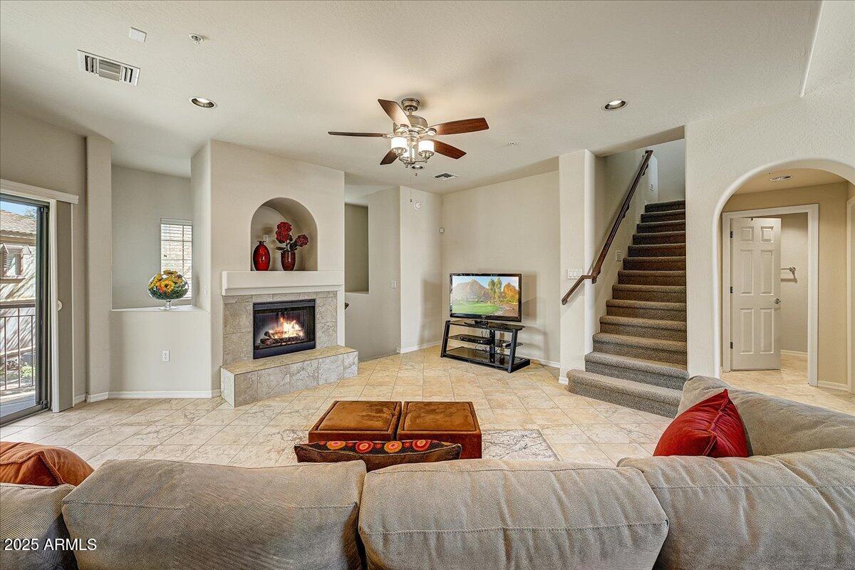 3935 East Rough Rider Road, Unit 1191 Phoenix, AZ 85050 - Photo 7 of 32 a bedroom with a bed and a fireplace