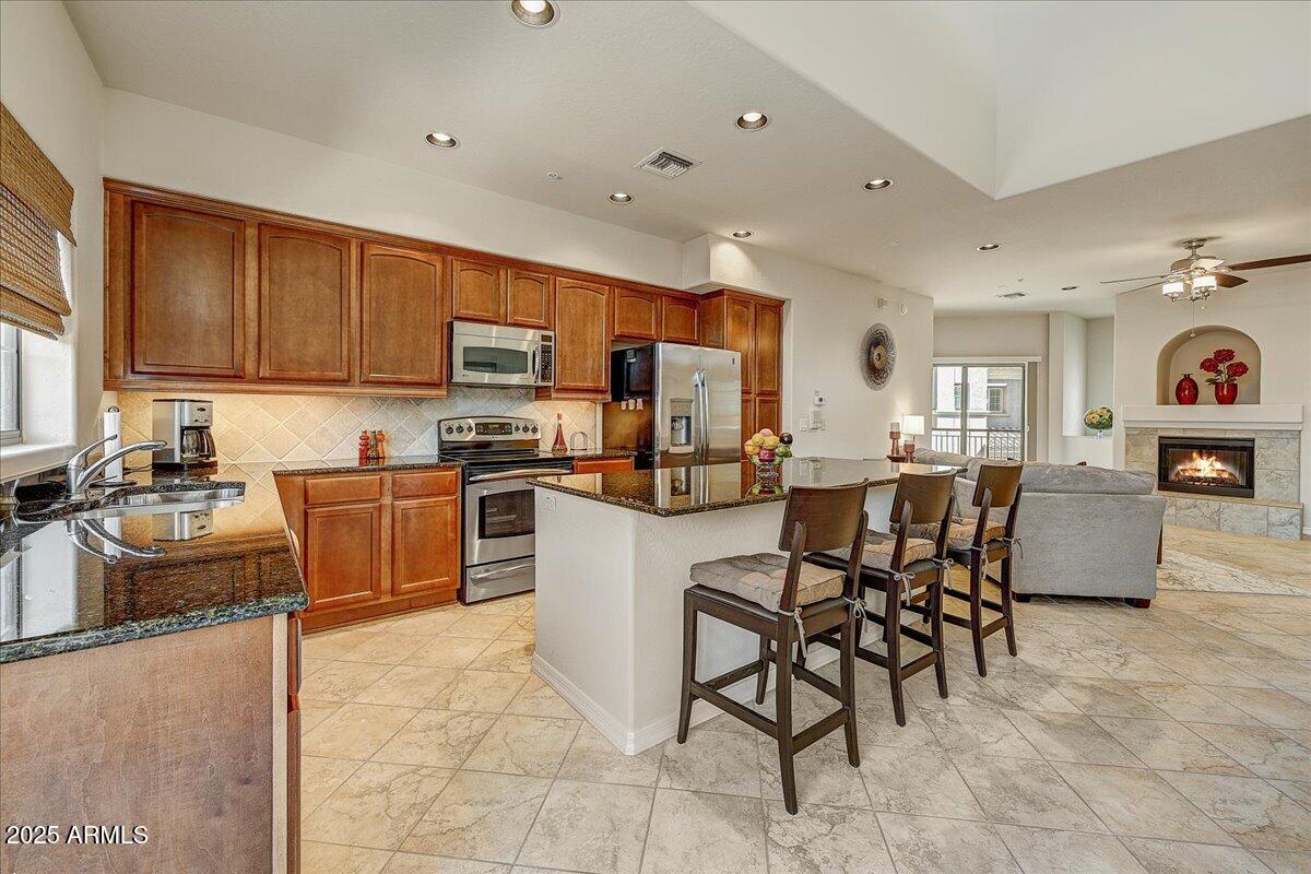 3935 East Rough Rider Road, Unit 1191 Phoenix, AZ 85050 - Photo 10 of 32 a kitchen with counter top space appliances and cabinets