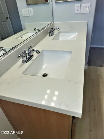 a bathroom with a tub shower sink and mirror