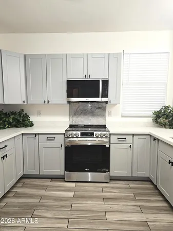 a kitchen with granite countertop a stove and a sink