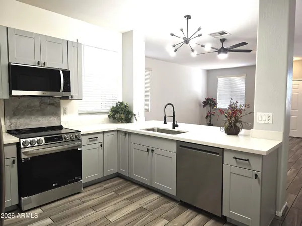 a kitchen with a sink stove and microwave