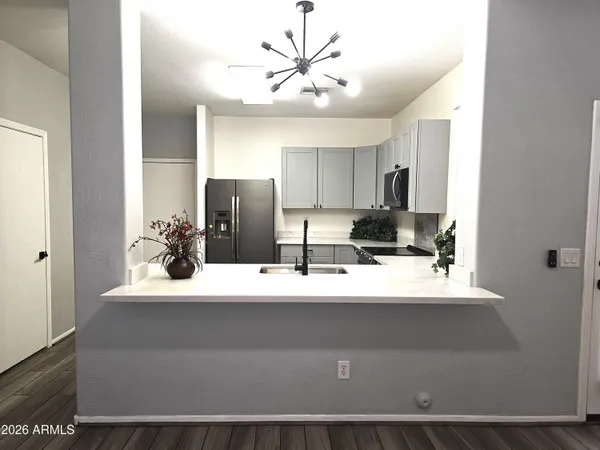 a view of kitchen with refrigerator and cabinets