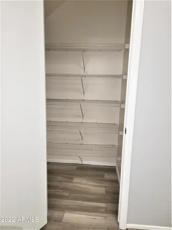 a view of walk in closet with empty racks