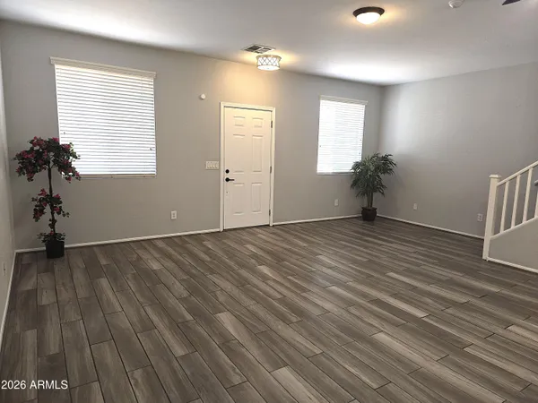 wooden floor in an empty room with a window