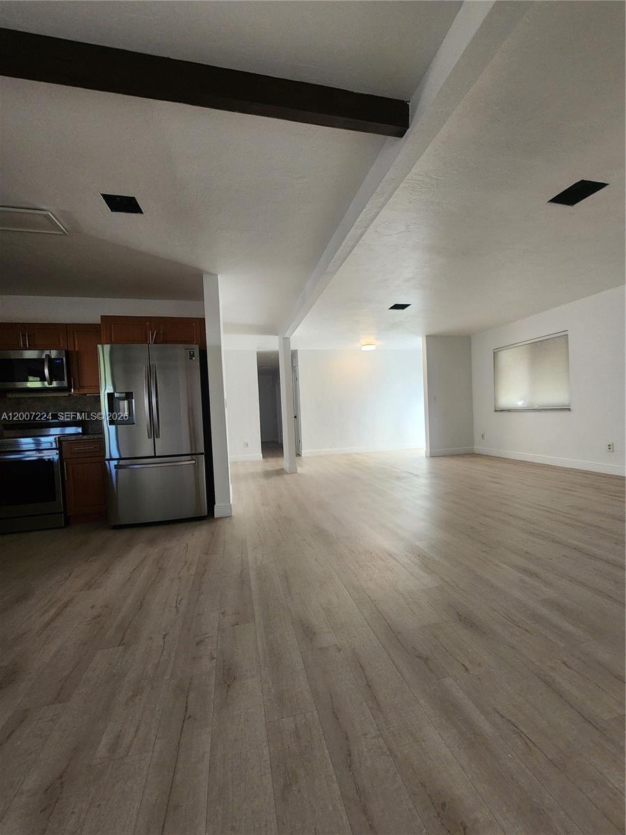 11025 Southwest 138th Court, Unit 11025 Miami, FL 33186 - Photo 14 of 21 a view of a big room with wooden floor