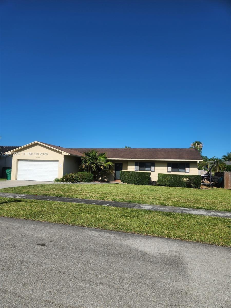 11025 Southwest 138th Court, Unit 11025 Miami, FL 33186 - Photo 2 of 21 a view of a house with a yard and a large tree
