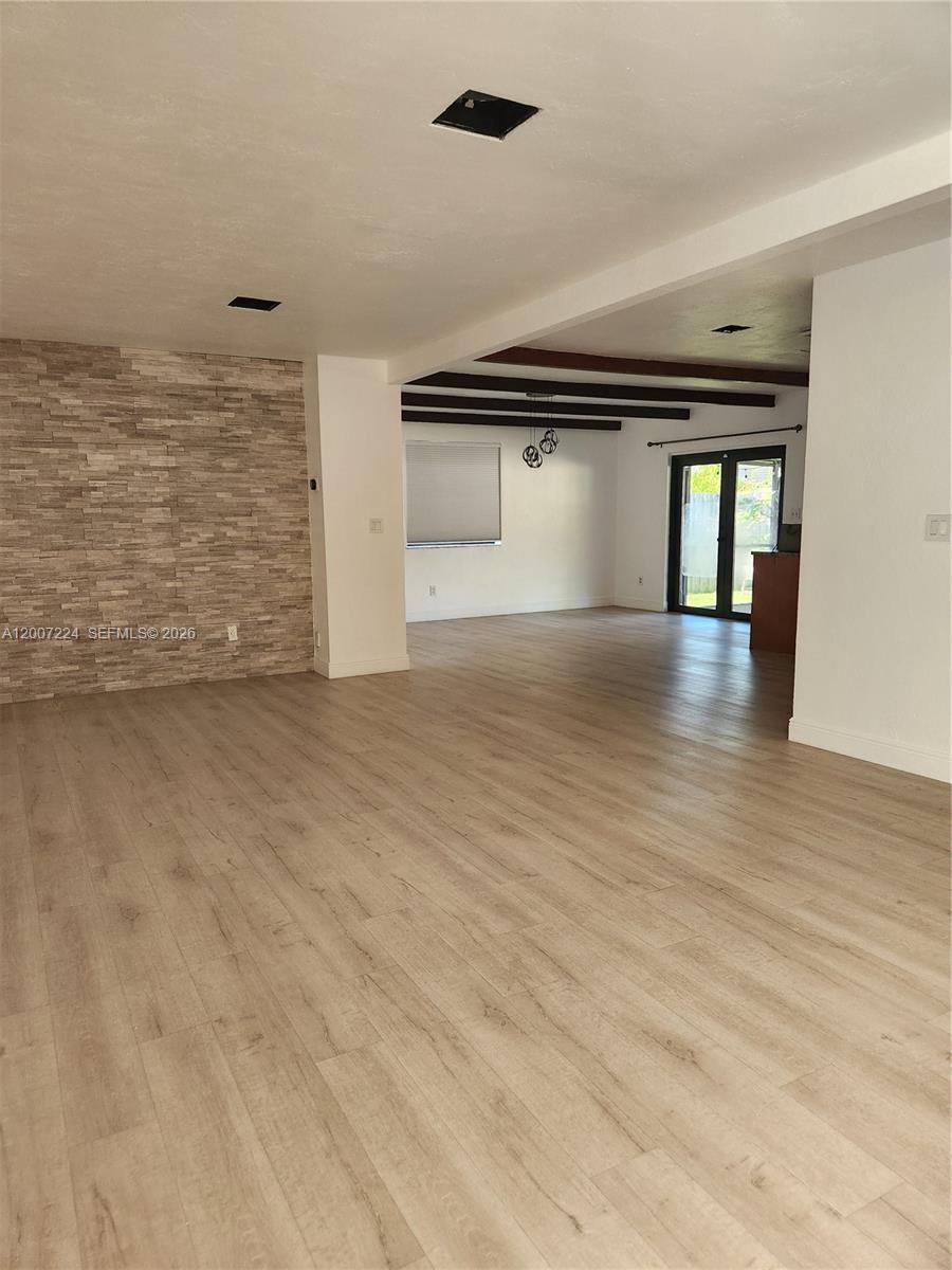 11025 Southwest 138th Court, Unit 11025 Miami, FL 33186 - Photo 4 of 21 a view of empty room with wooden floor and window