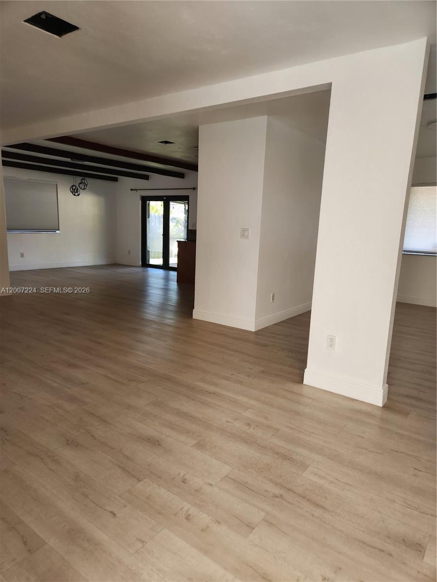 11025 Southwest 138th Court, Unit 11025 Miami, FL 33186 - Photo 8 of 21 an empty room with wooden floor and windows