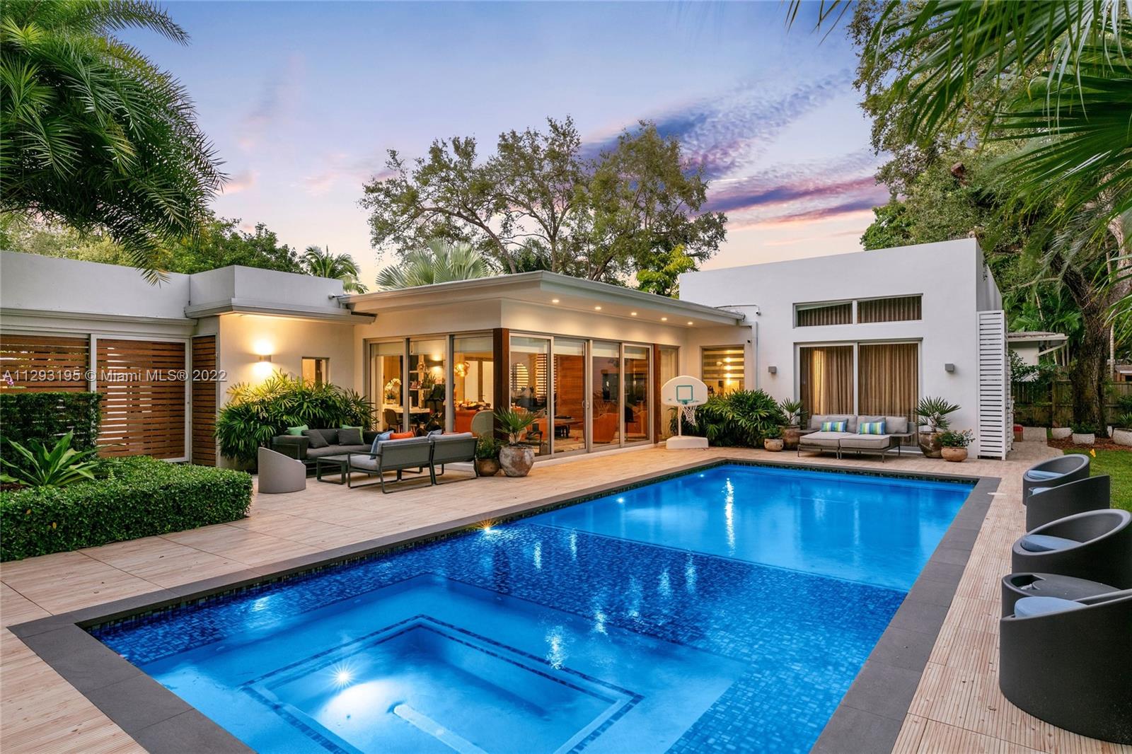 a view of a house with swimming pool and sitting area