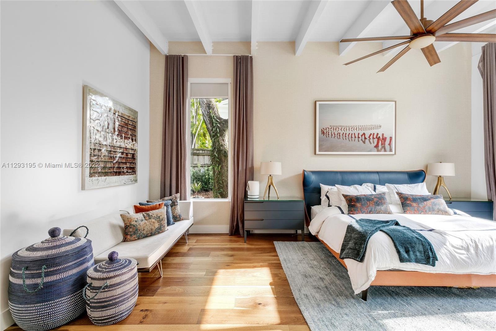 1666 Tigertail Avenue Miami, FL 33133 - Photo 16 of 41 a spacious bedroom with a bed and wooden floor