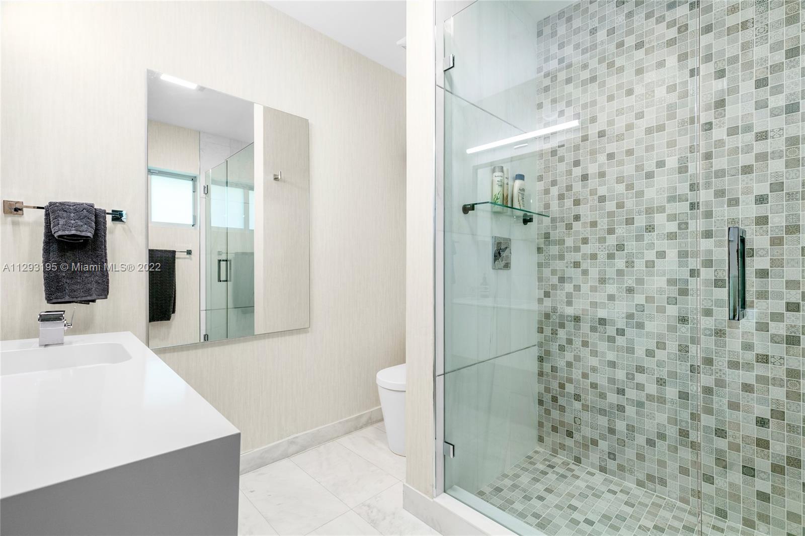 1666 Tigertail Avenue Miami, FL 33133 - Photo 25 of 41 a bathroom with a sink a toilet and shower