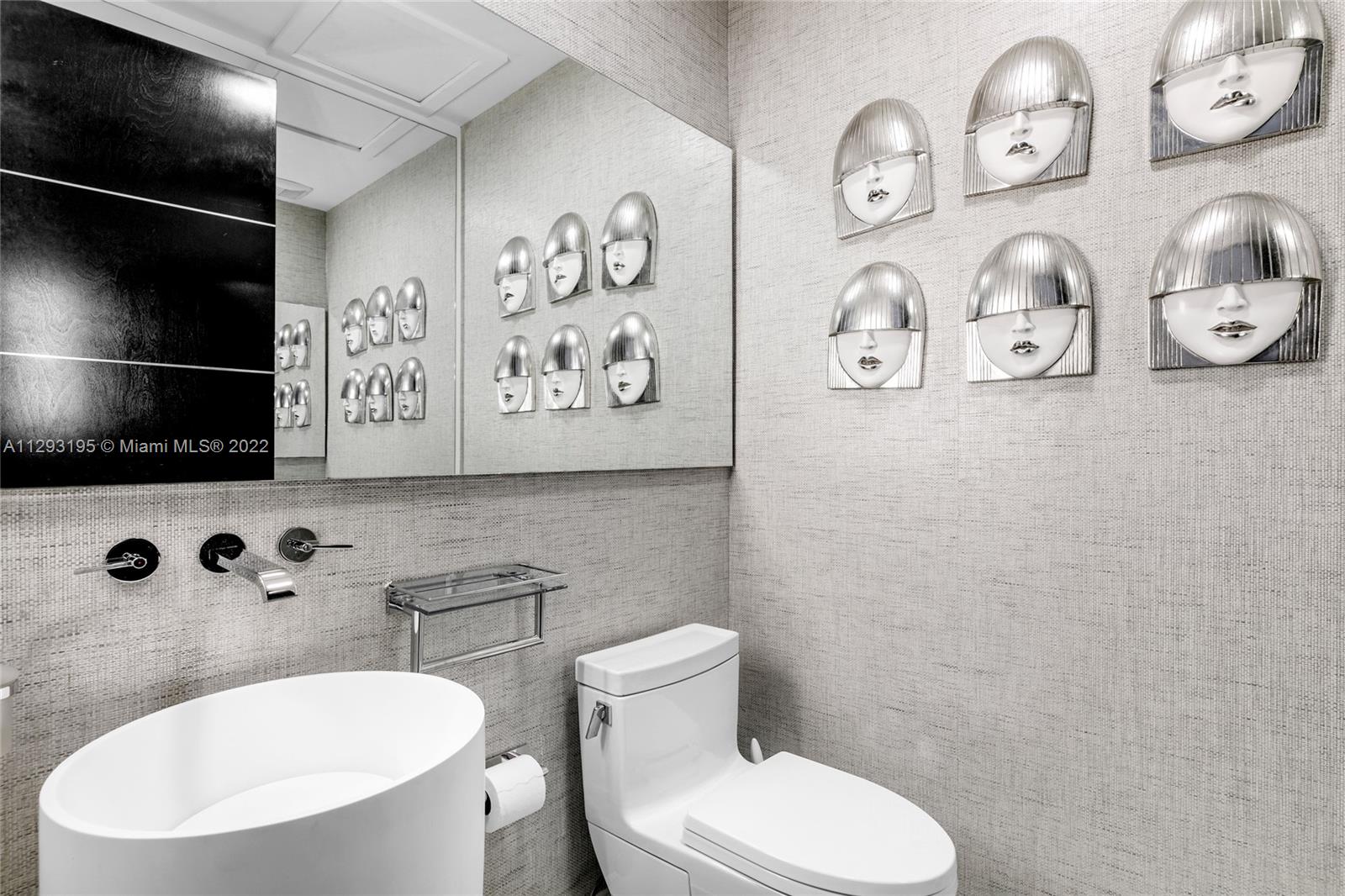 1666 Tigertail Avenue Miami, FL 33133 - Photo 28 of 41 a bathroom with a toilet a sink and a mirror