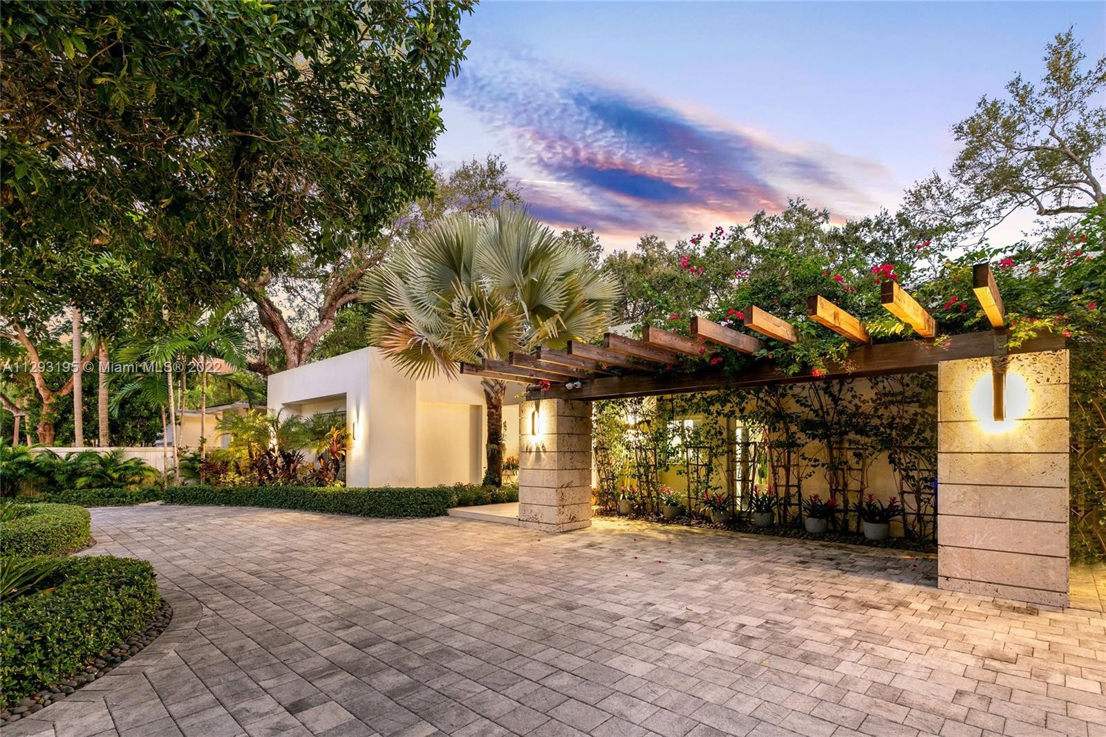 1666 Tigertail Avenue Miami, FL 33133 - Photo 37 of 41 a front view of a house with a yard and garage
