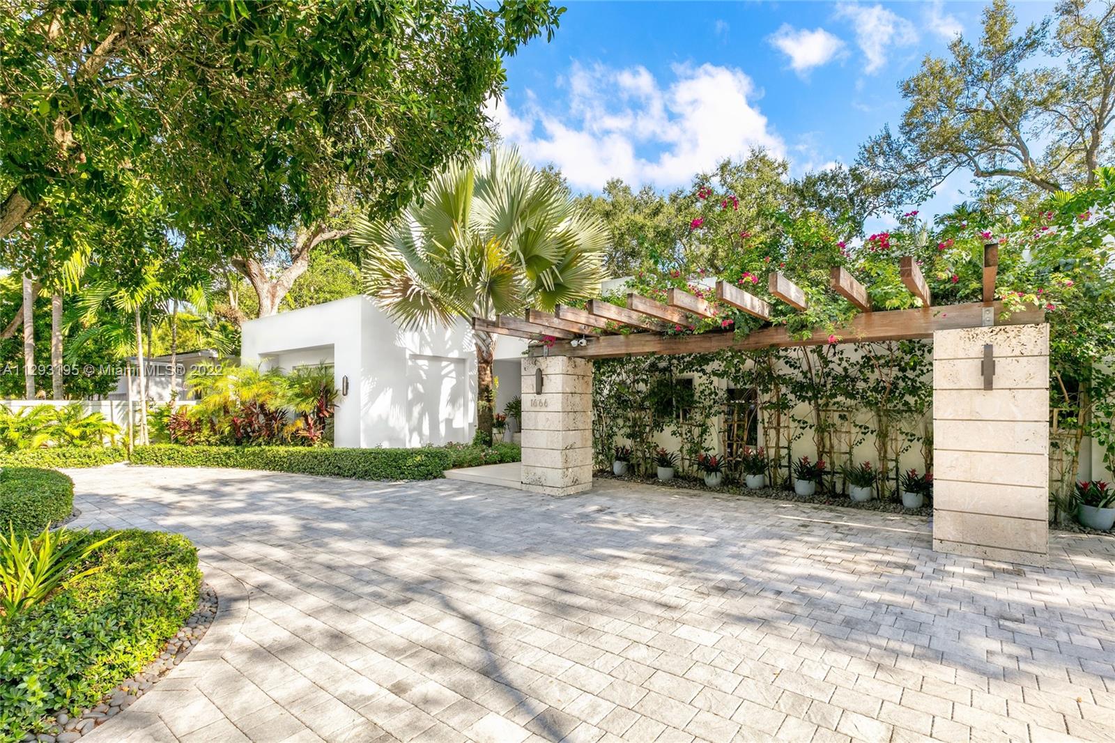 1666 Tigertail Avenue Miami, FL 33133 - Photo 5 of 41 a view of a house with a yard and garage