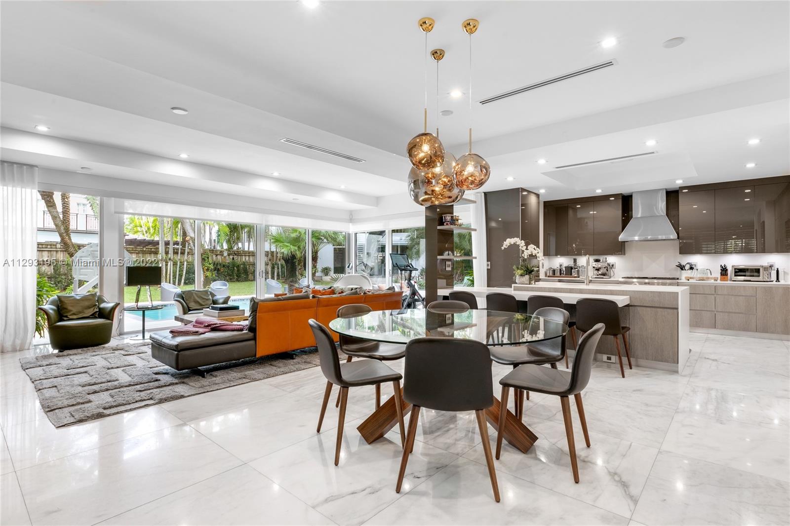 1666 Tigertail Avenue Miami, FL 33133 - Photo 7 of 41 a dining room with furniture a chandelier and a large window