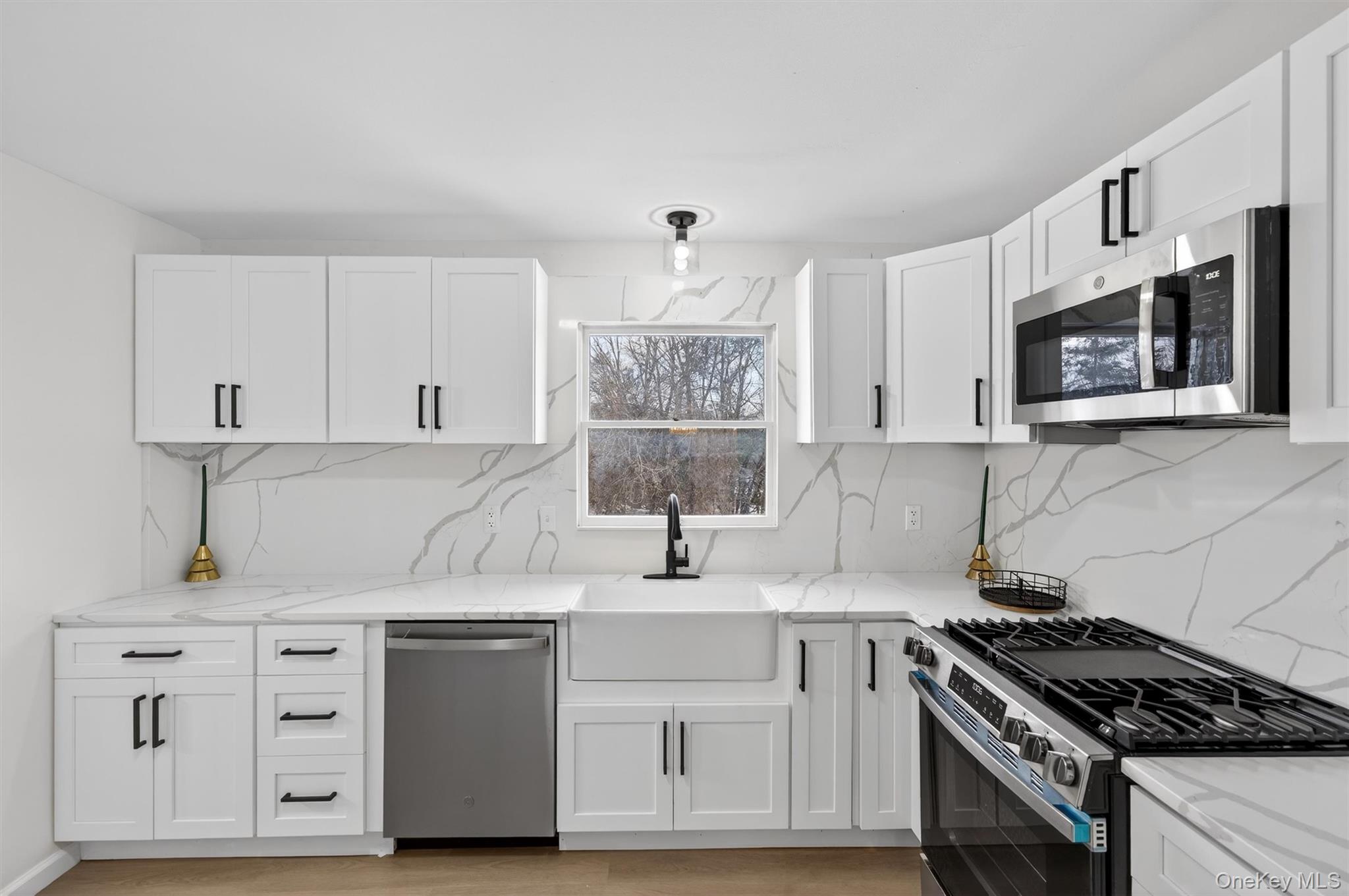 7 Edenville Road Warwick, NY 10990 - Photo 11 of 38 Kitchen with stainless steel appliances, backsplash, light stone countertops, and white cabinetry