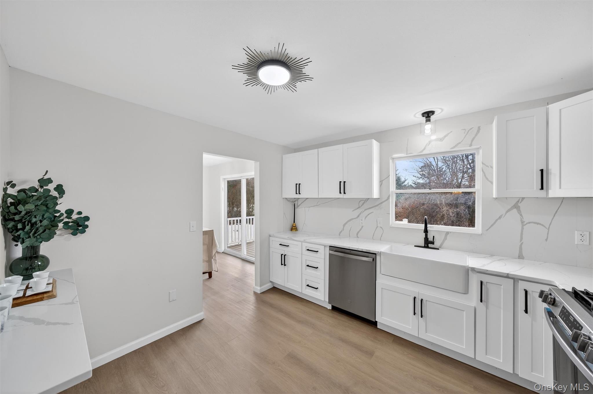 7 Edenville Road Warwick, NY 10990 - Photo 14 of 43 a large white kitchen with a sink dishwasher and a stove with wooden floor