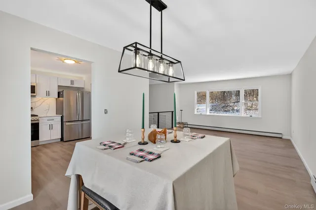 an empty room with wooden floor ceiling fan and windows