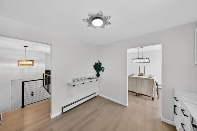 an empty room with ceiling fan and window