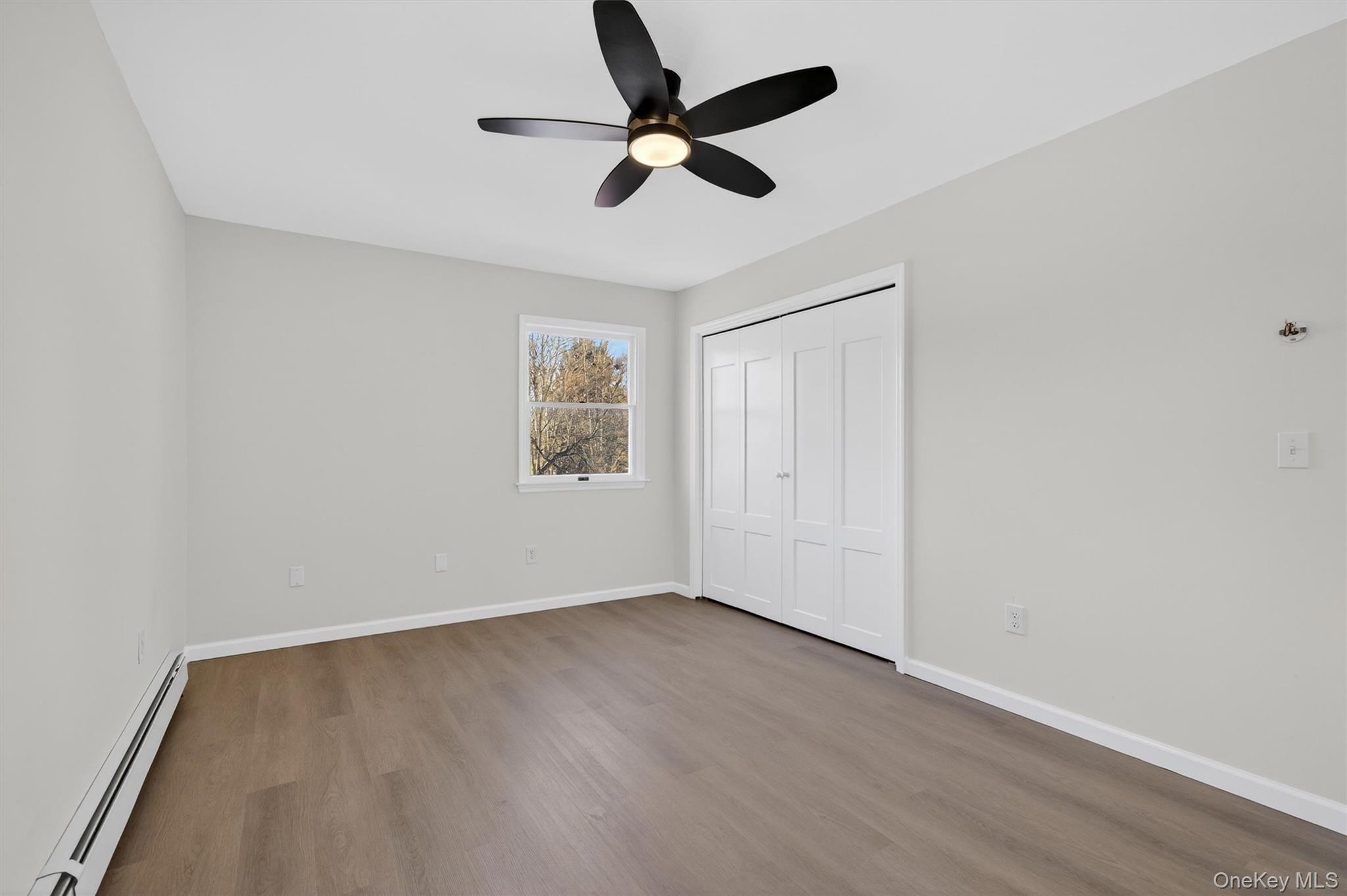 7 Edenville Road Warwick, NY 10990 - Photo 23 of 43 an empty room with wooden floor ceiling fan and windows