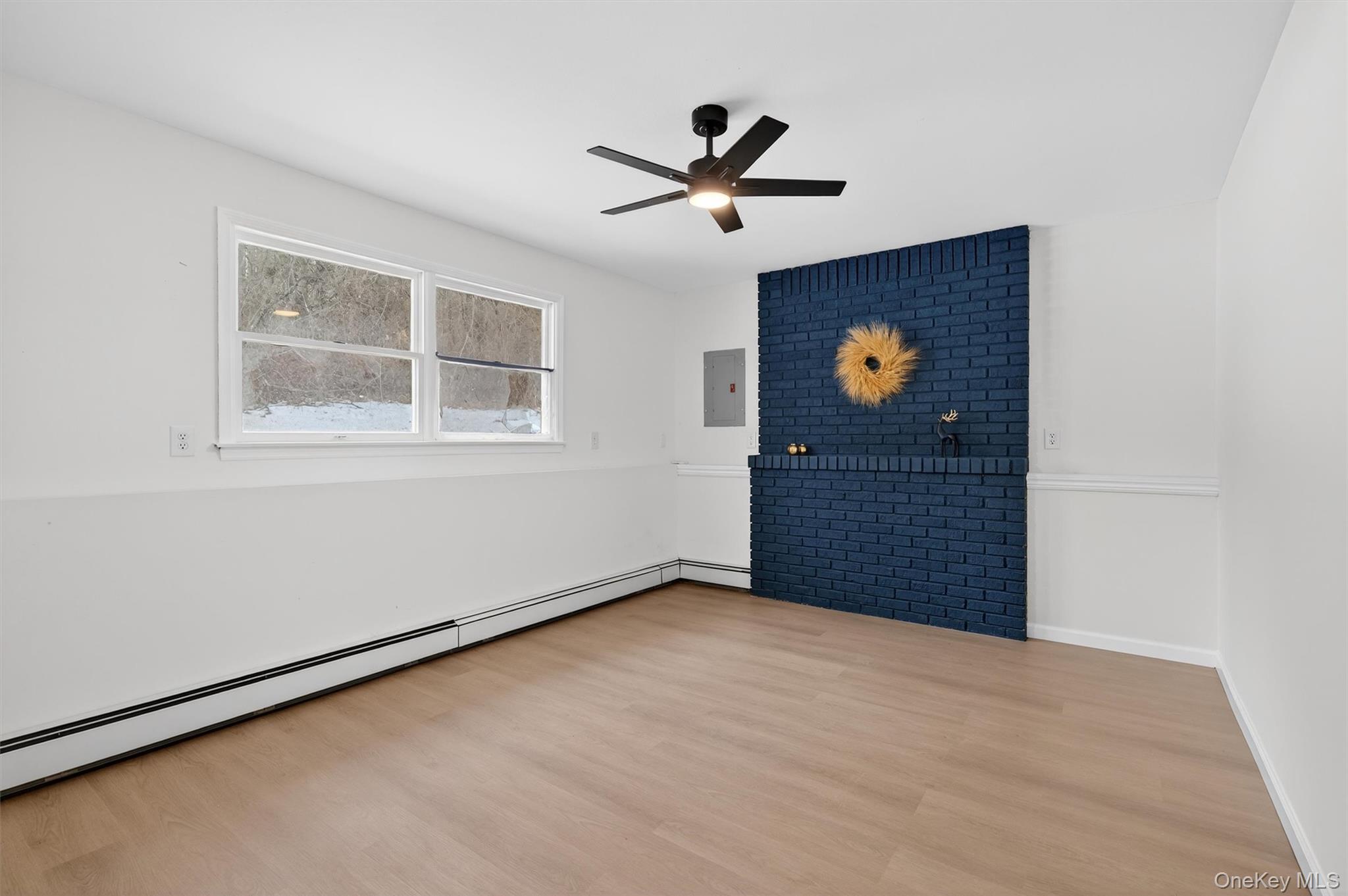 7 Edenville Road Warwick, NY 10990 - Photo 28 of 38 Unfurnished room featuring baseboard heating, light wood-type flooring, a ceiling fan, and electric panel
