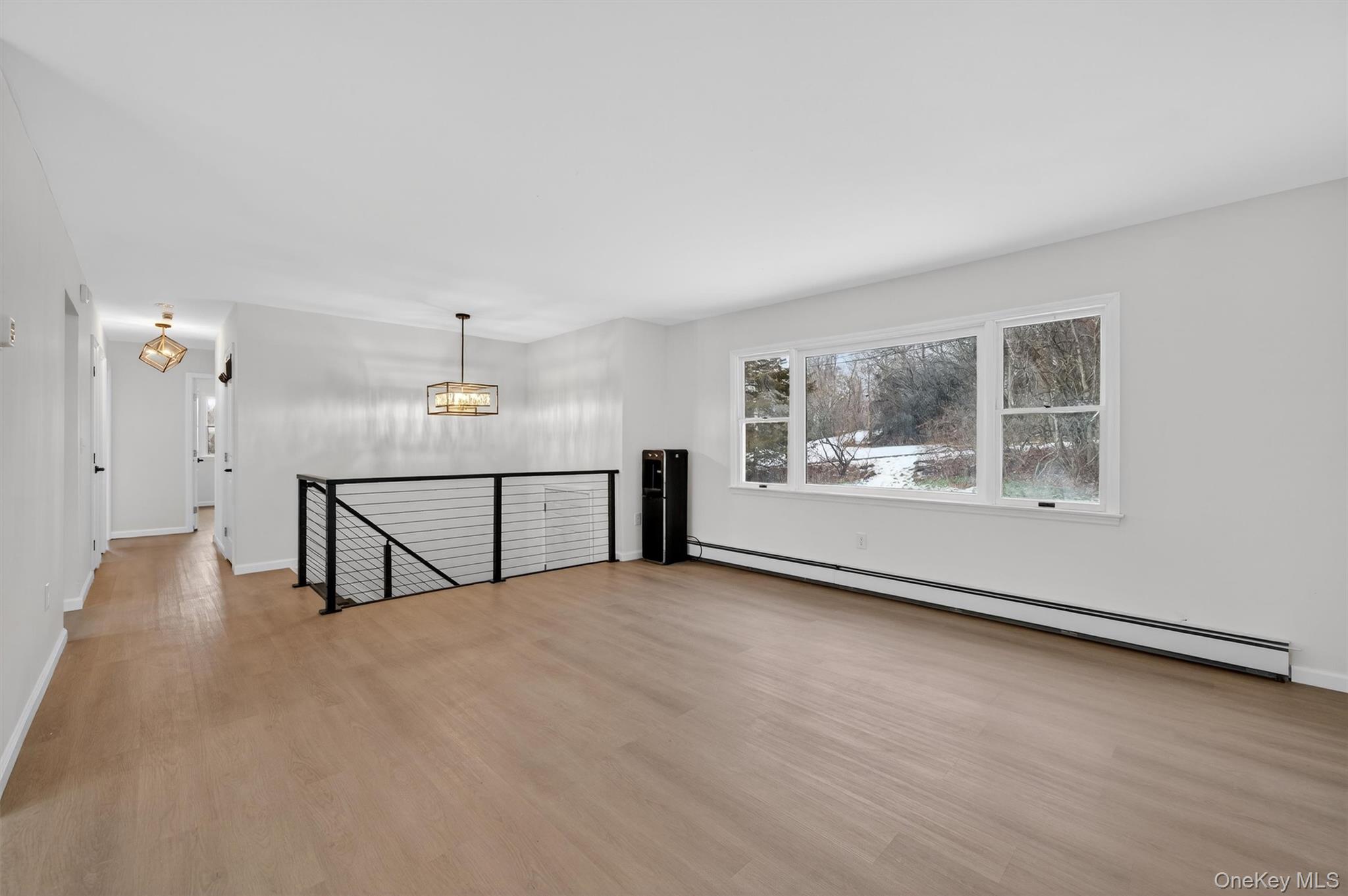 7 Edenville Road Warwick, NY 10990 - Photo 7 of 43 an empty room with chandelier fan and windows