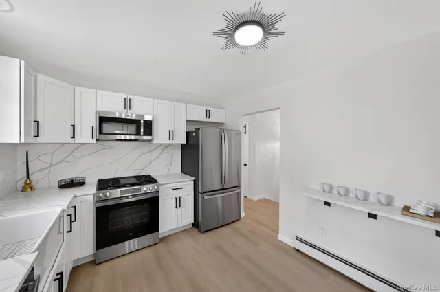 a view of a dining room with furniture and a chandelier