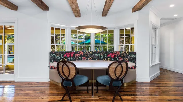 a view of a dining room with furniture and chandelier